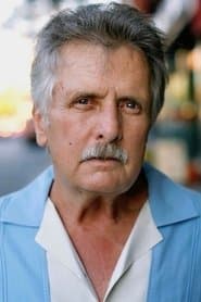 Joe Estevez في دور Tom Baldwin
