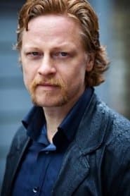 Patrick Garrow dans le rôle de Touhey