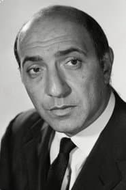 George Pastell في دور Inspector Etienne
