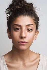 Anna Antoniades في دور Airport Announcer / Female Club Rep
