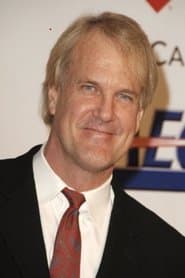 John Tesh dans le rôle de TV Newscaster