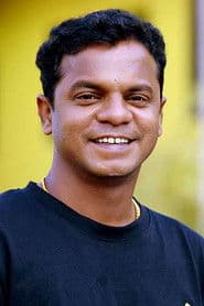 Dharmajan Bolgatty dans le rôle de Jyothisharathnam Poomeni Illath Brahmashri Biju Brahmanan